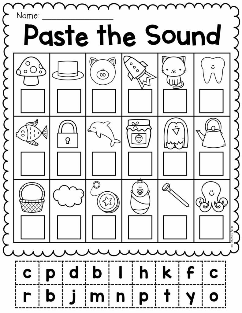 A close-up of a teacher reviewing a phonics worksheet with a student